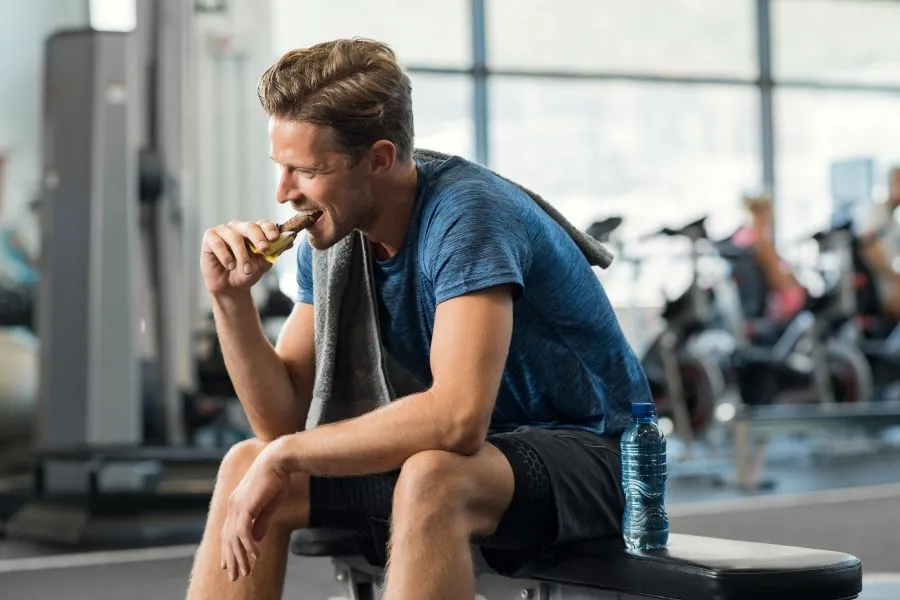 Man eating a protein bar
